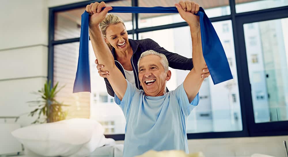Shot of a physiotherapist helping a senior patient stretch