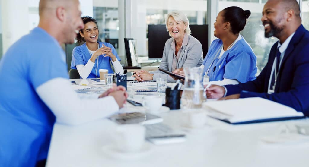 Boardroom, collaboration and healthcare with hospital manager speaking to staff